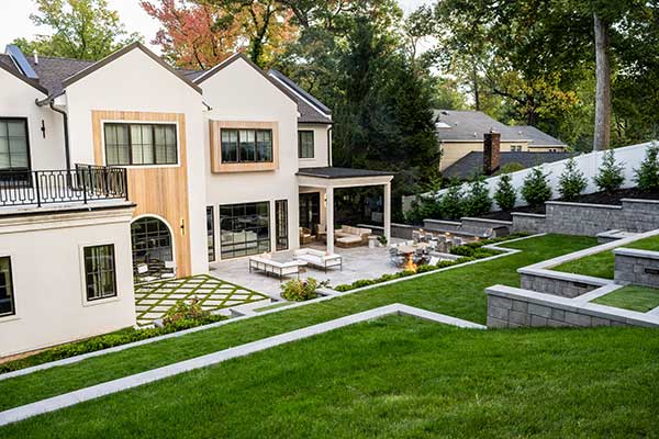 Outdoor kitchen construction with stone countertops and built-in appliances in Irvine home